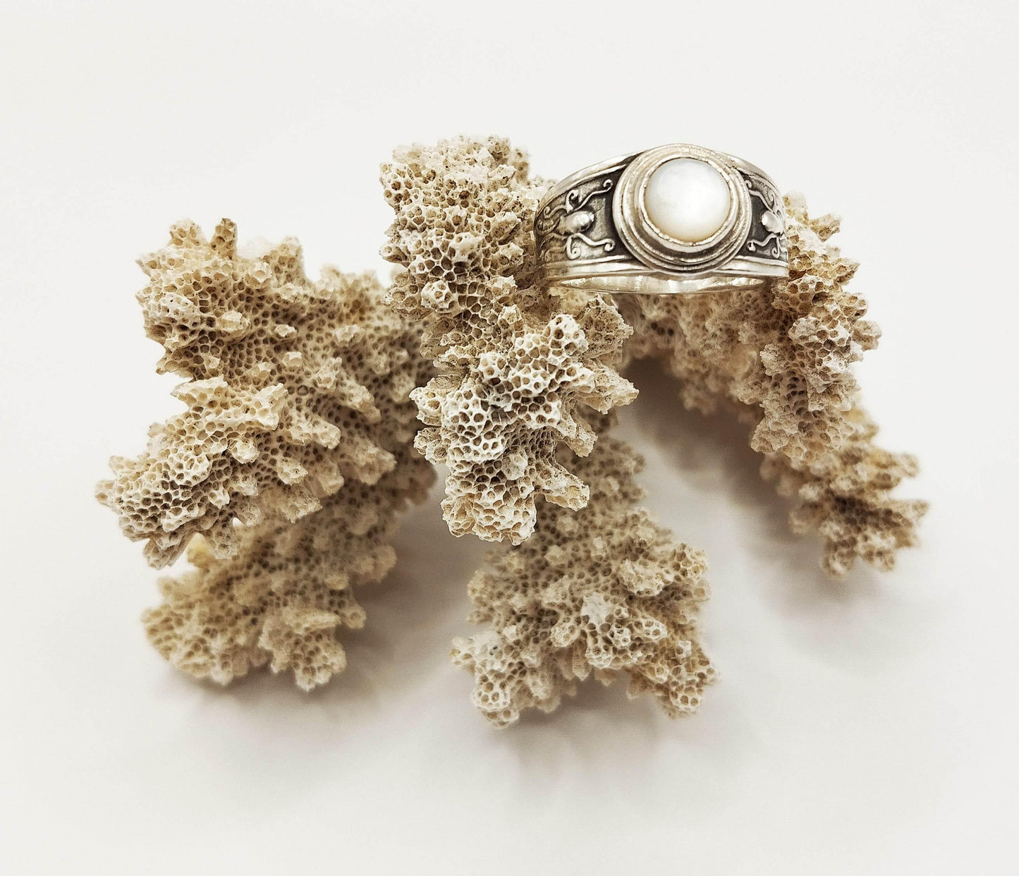 Ασημένιο δαχτυλίδι με στρογγυλό στοιχείο από φίλντισι στο κέντρο και ανάγλυφο σχέδιο χταποδιού εκατέρωθεν.
Υπέροχο, καλοκαιρινό κόσμημα, εμπνευσμένο από τον κόσμο της θάλασσας.