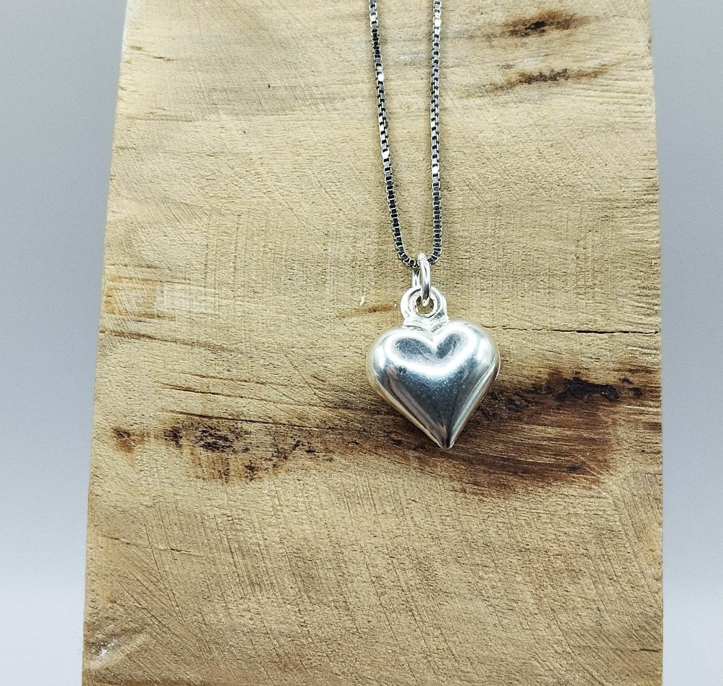 Ασημένιο κολιέ με ασημένιο μενταγιόν σε σχήμα φουσκωτής καρδιάς.