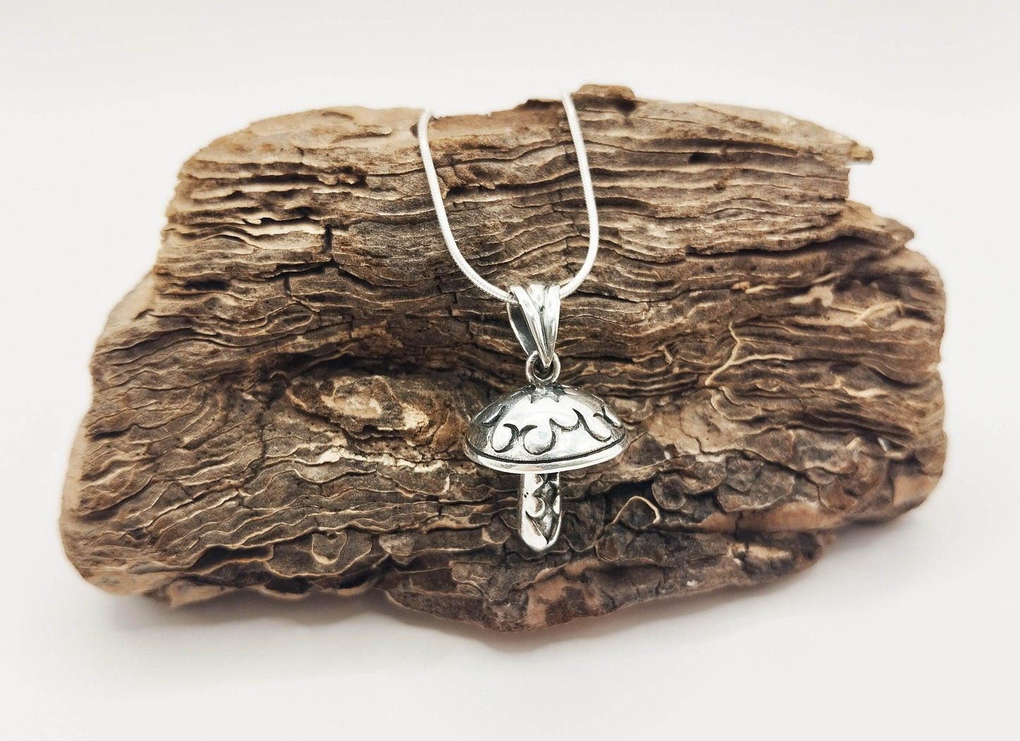 Ασημένιο κολιέ με ασημένιο μενταγιόν σε σχήμα μανιταριού διακοσμημένο με εγχάρακτα σχέδια.