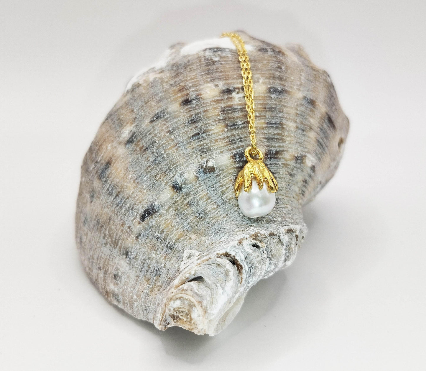 Κολιέ από επιχρυσωμένο ασήμι με κρεμαστό ασύμμετρο μαργαριτάρι.